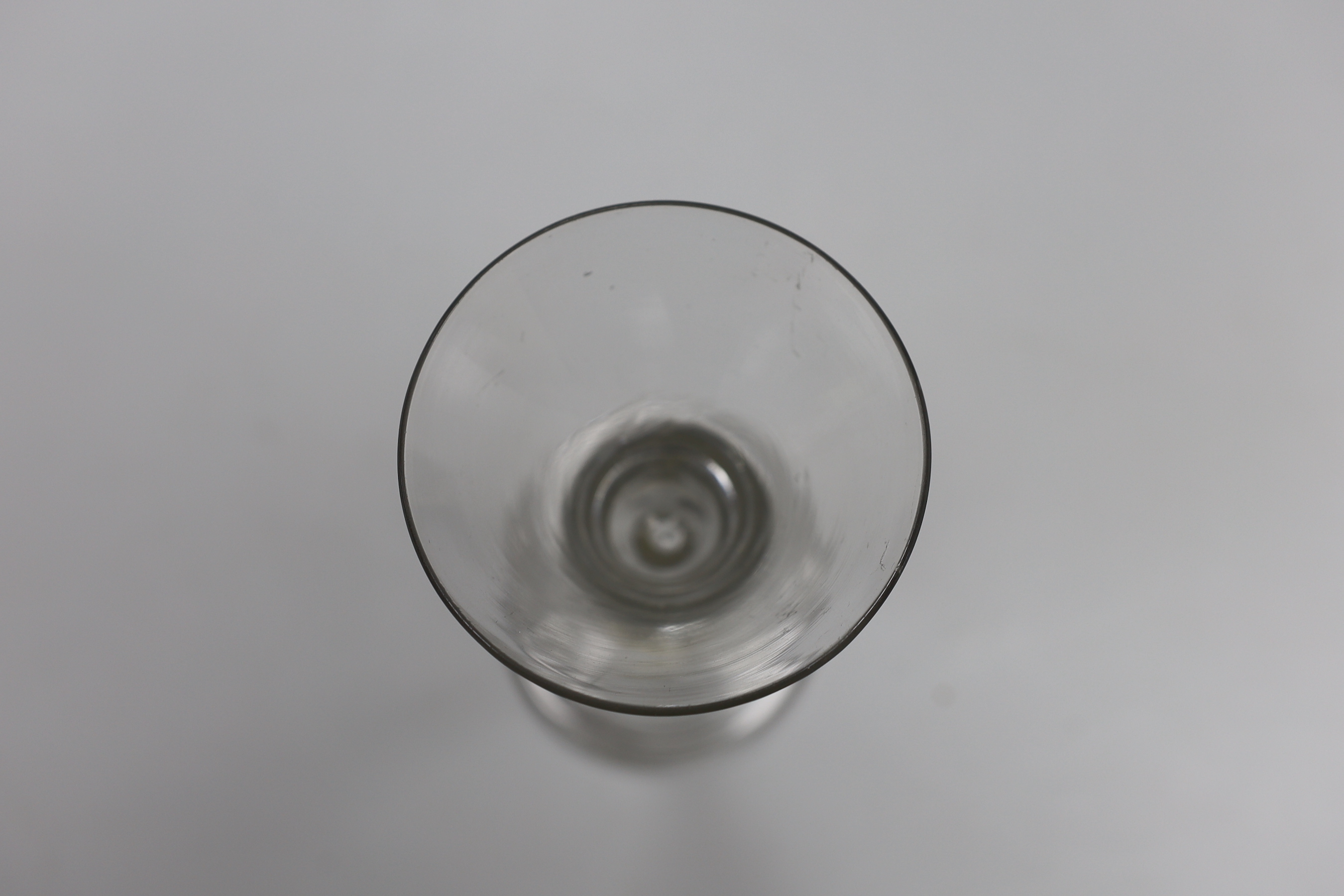 A George II wine glass, bell bowl with air-tear, folded foot, 16cm tall